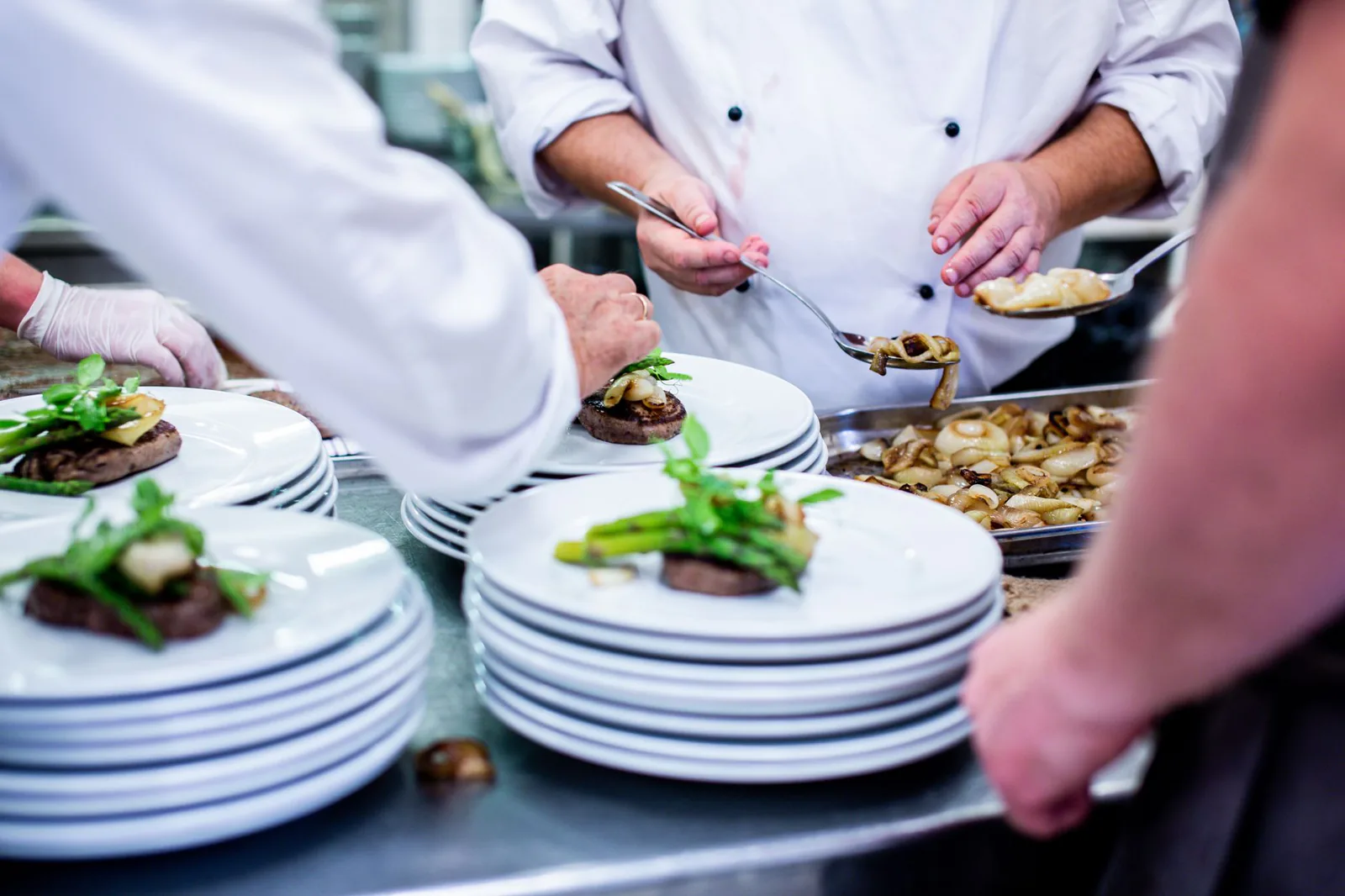 Professional chefs plating gourmet dishes